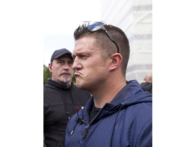 - London, Greater London, UNITED KINGDOM : Leader of the right-wing EDL (English Defence League) Tommy Robinson aka Stephen Yaxley-Lennon (R) waits before at a protest in central London on September 7, 2013. Members of the EDL assembled in central London despite losing a high court battle to demonstrate in the Tower Hamlets area of East London, which they claim is subjected to Sharia Law. AFP PHOTO / JUSTIN TALLIS