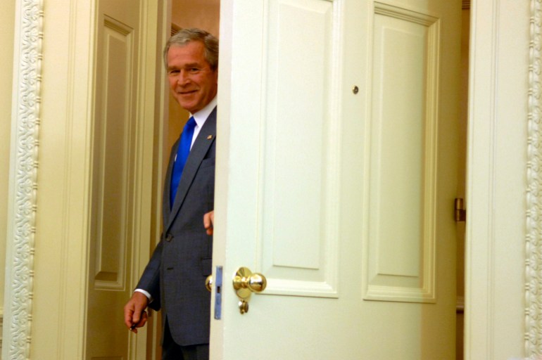 U.S. President George W. Bush peeks into the room before making a statement in the Oval Office after signing an Iraq war supplemental bill at the White House in Washington, June 30, 2008. REUTERS/Jonathan Ernst (UNITED STATES)